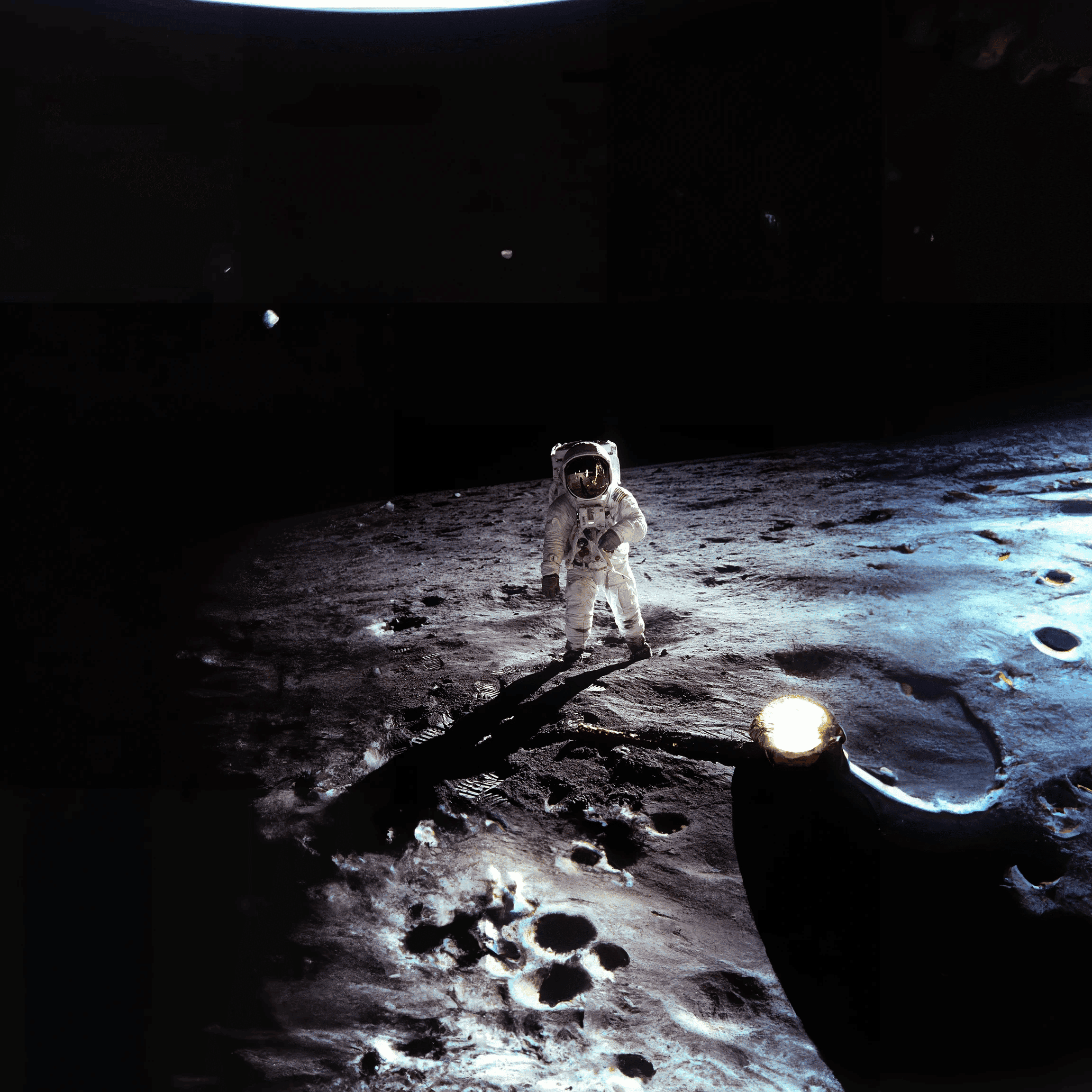 outpainted image with DALL-E 2 showing expanded version of original photo of Apollo 11 astronaut Buzz Aldrin walking on the surface of the moon near the leg of the lunar module Eagle